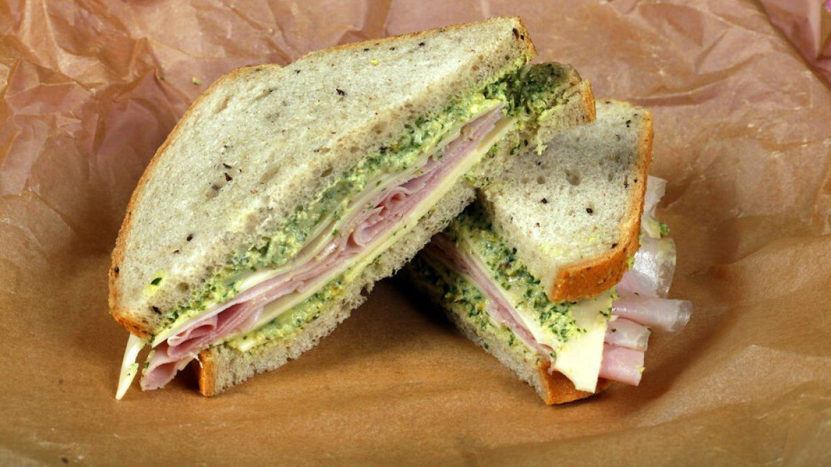 File: This photo shows a ham and cheese sandwich with green spread, styled by Sarah Abrams, displayed at the Institute of Culinary Education in New York, US, 4 August, 2016.