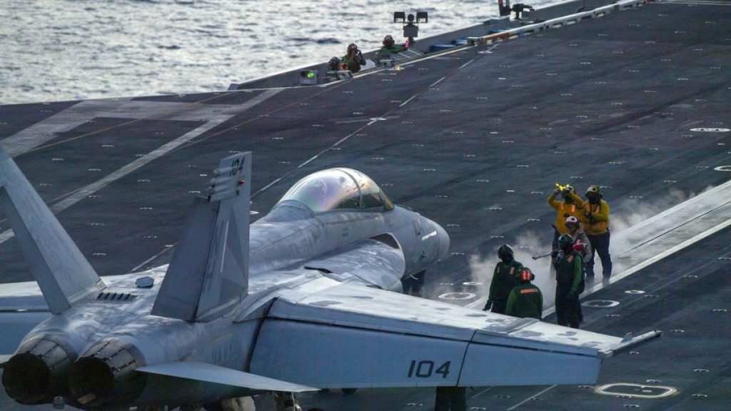 FILE - An F/A-18 Super Hornet prepares to launch off the flight deck of the Nimitz-class aircraft carrier USS Theodore Roosevelt onJuly 5, 2024, in the South China Sea.