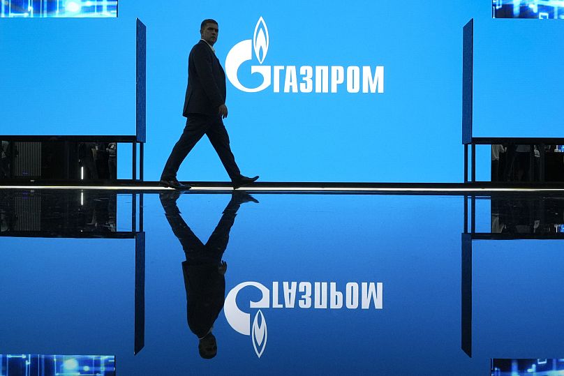 Un homme passe devant le logo de Gazprom lors d'une exposition au Forum international du gaz de Saint-Pétersbourg, le 14 septembre 2022.