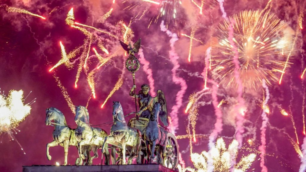 Fireworks light the sky above the Quadriga at the Brandenburg Gate during New Year