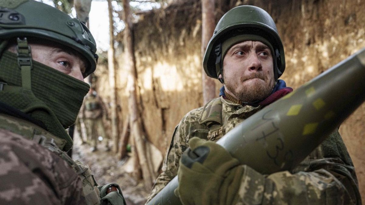 Ukrainian servicemen of 26th artillery brigade load ammunition into a self-propelled howitzer before firing towards Russian positions at the frontline in Donetsk region