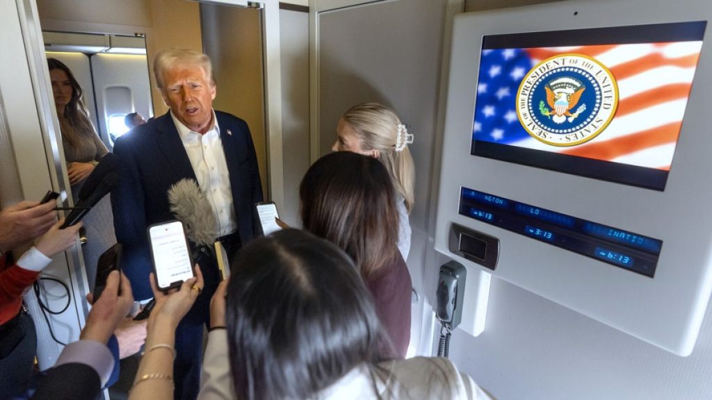 President Donald Trump speaks to reporters aboard Air Force One as he travels from Las Vegas to Miami on Saturday, Jan. 25, 2025. (AP Photo/Mark Schiefelbein)