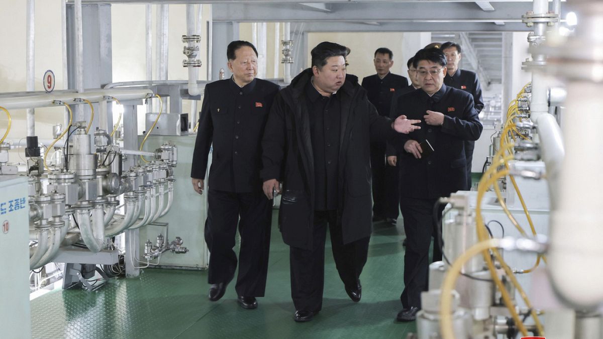 In this undated photo provided Wednesday, Jan. 29, 2025, by the North Korean government, Kim Jong Un, second right, inspects a facility that produces nuclear material
