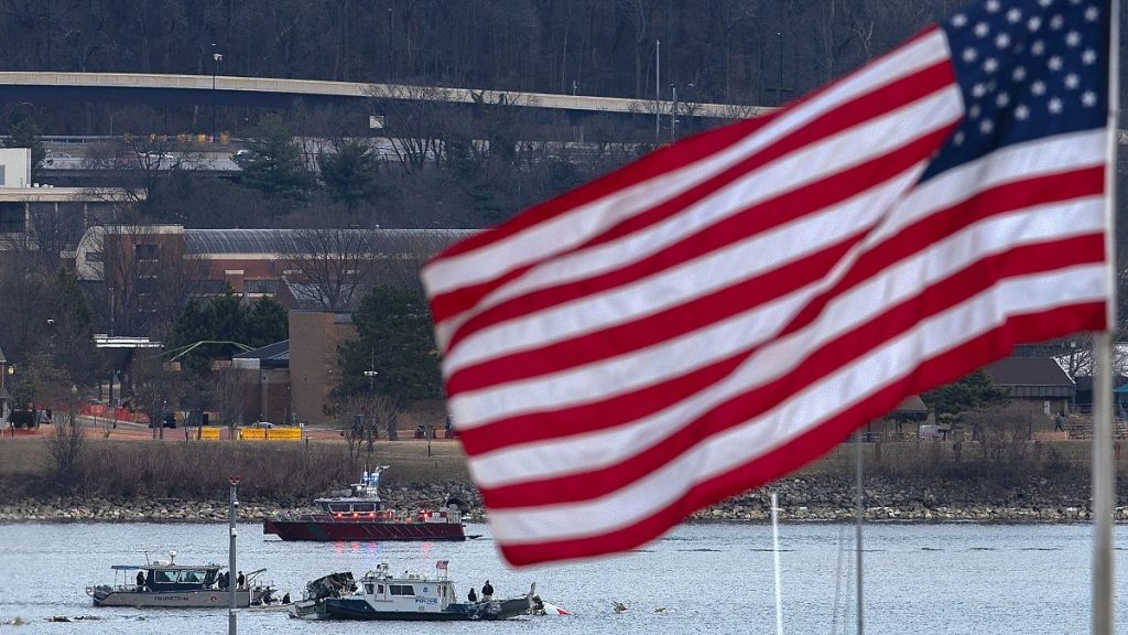 A diving team and police boat are seen around a wreckage site in the Potomac River from Ronald Reagan Washington National Airport, 30 January, 2025