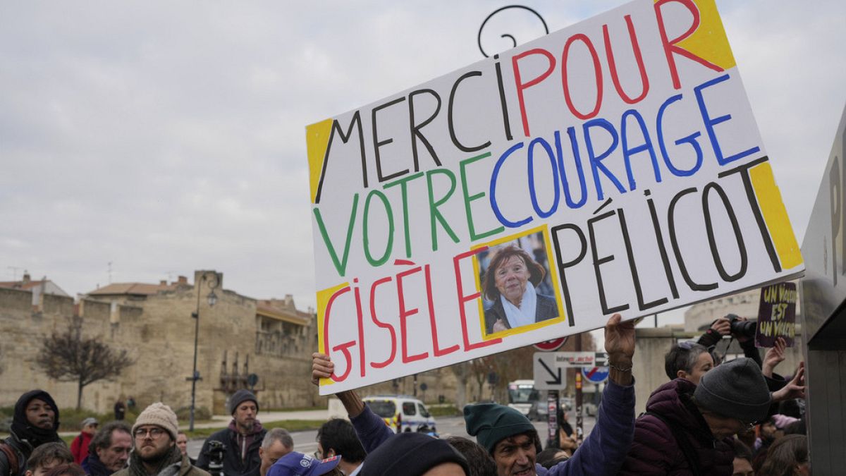 FILE: A man holds a placard reading
