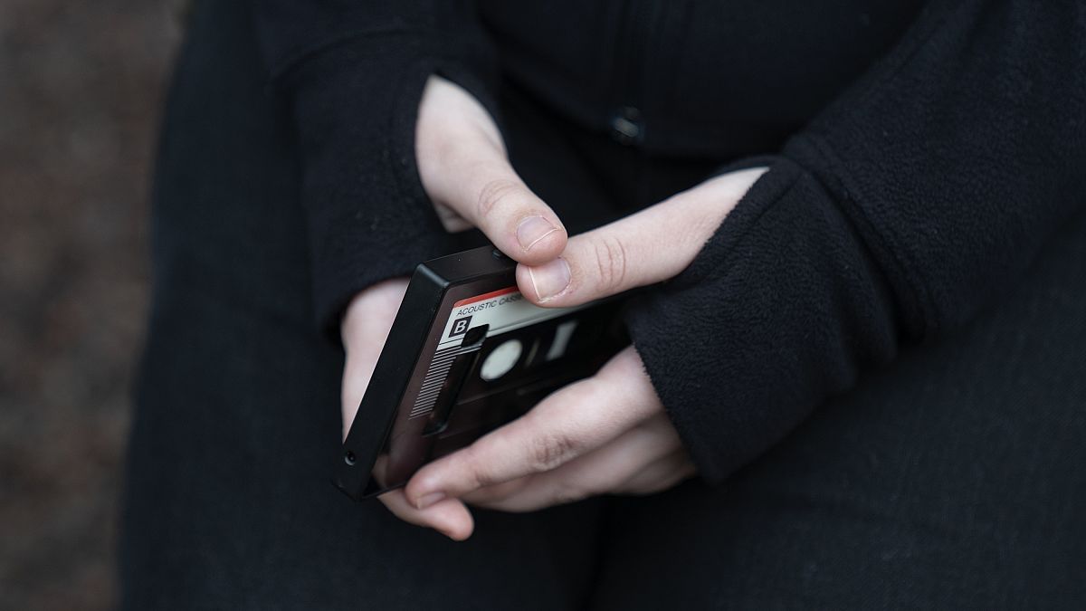 A teenager holds her phone.