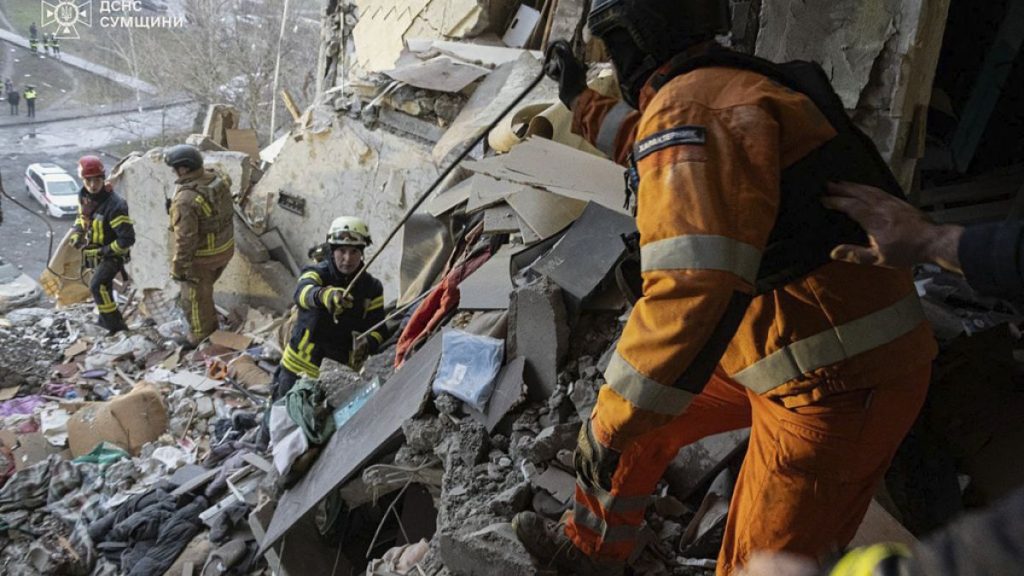 Rescuers search for civilians who were killed when a Russian drone hit an apartment building in Sumy, Ukraine, Thursday, Jan. 30, 2025.
