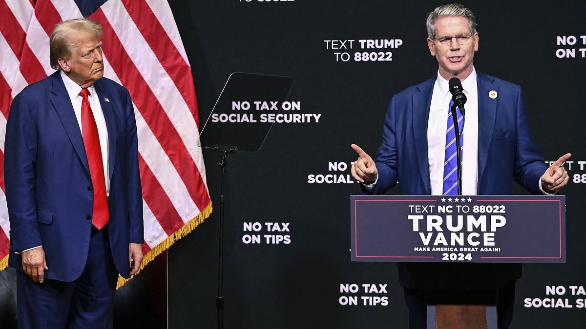 President-elect Donald Trump listens to investor Scott Bessent speaks on the economy during last year