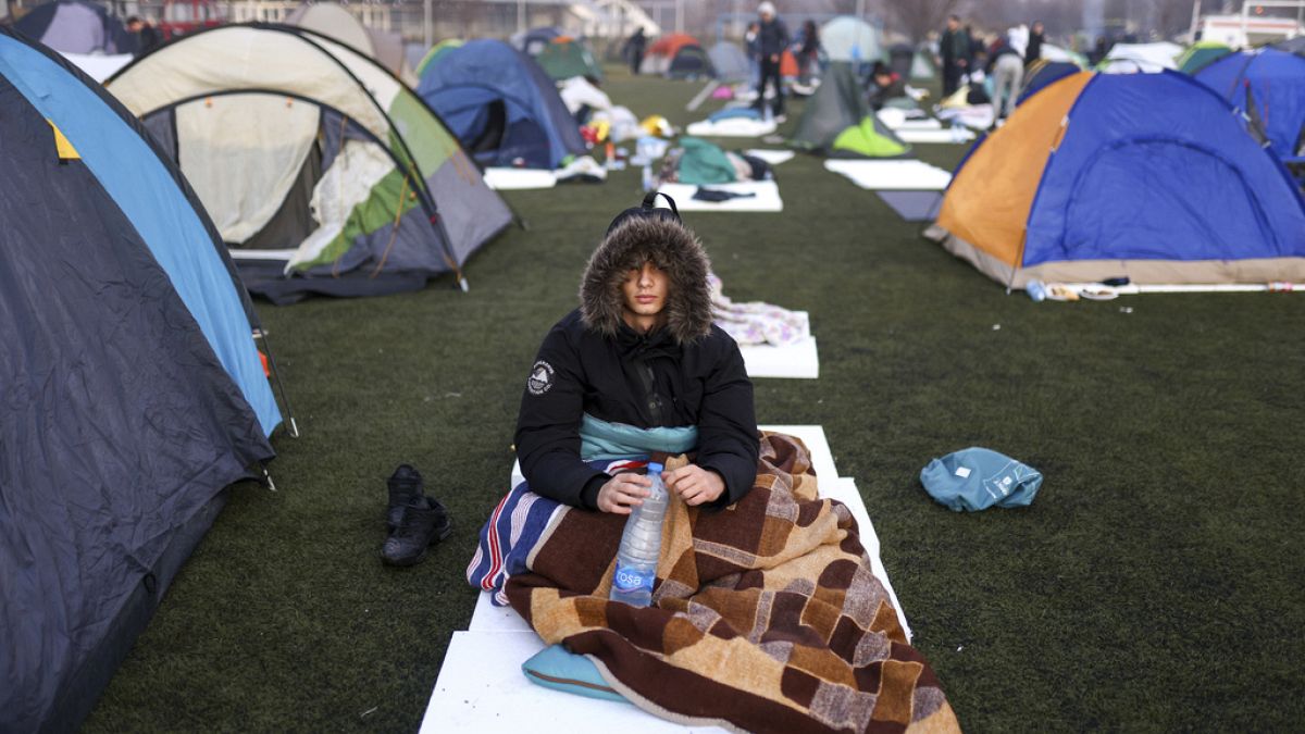 A student sits after waking up on a soccer stadium during a protest over the collapse of a concrete canopy that killed 15 people more than two months ago, in Indjija, Serbia.