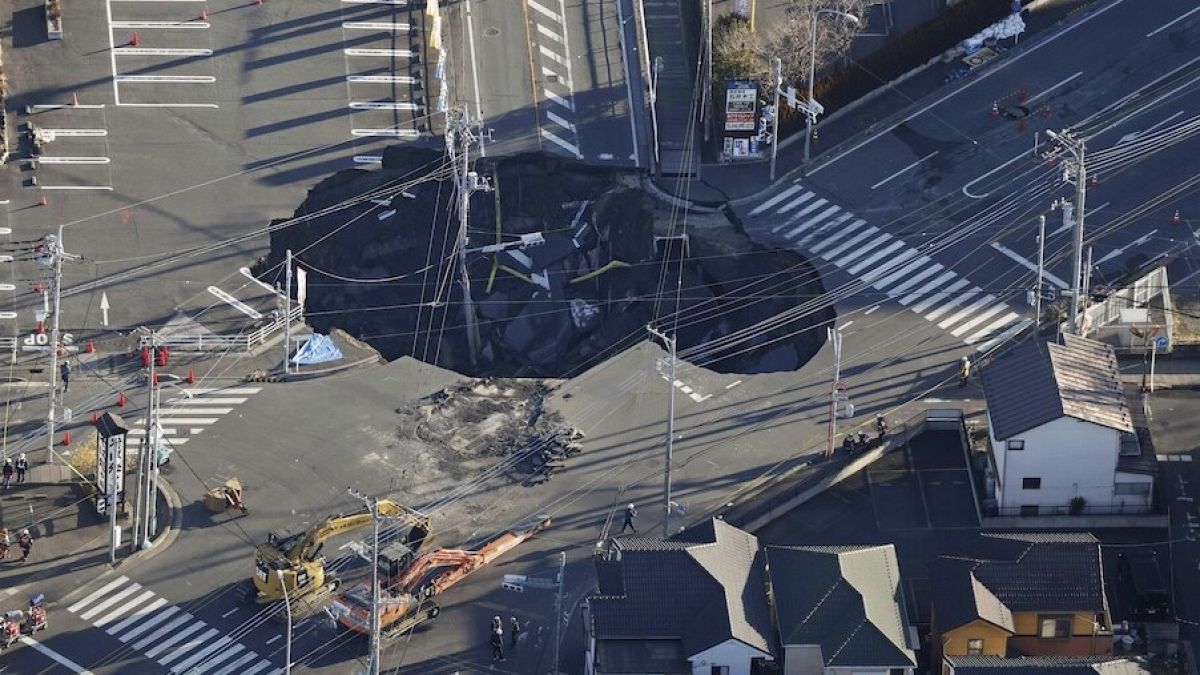 Police officers and rescue members prepare for a rescue mission in Yashio, northeast of Tokyo, Thursday, Jan. 30, 2025