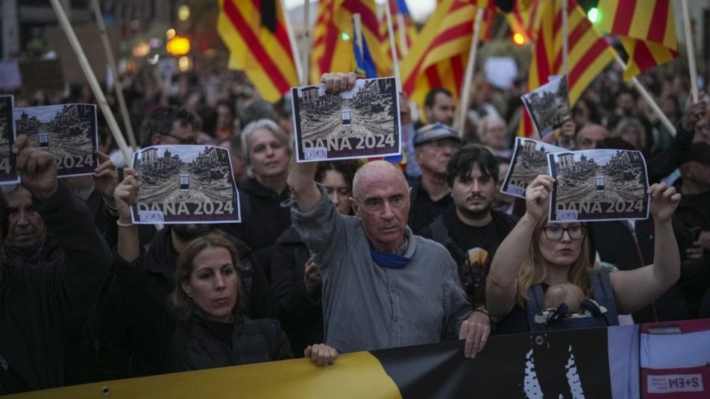 FILE: Demonstrators gather for a protest organized by social and civic groups, denouncing the handling of flooding in Valencia, Spain, Saturday, Nov. 9, 2024
