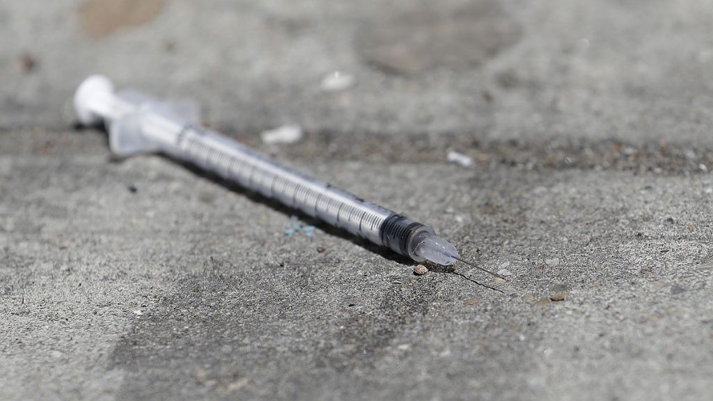 A used syringe is shown on a US sidewalk in this 2018 file photo.