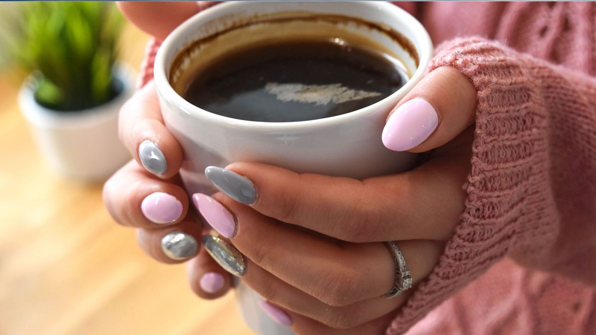 A person holding a coffee cup