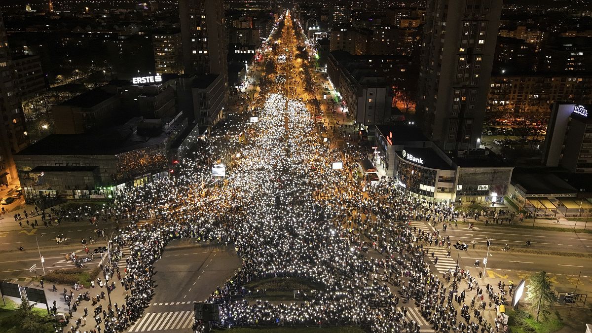 People hold their mobile phone lights during a protest in front of Novi Sad railway station where 15 people were killed in a concrete canopy collapse, 31 January, 2025