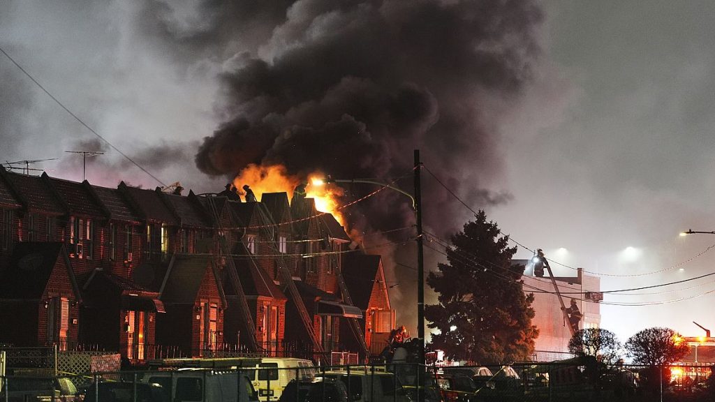 Smoke rises as first responders work at the scene after a small plane crashed in Philadelphia, 31 January, 2025