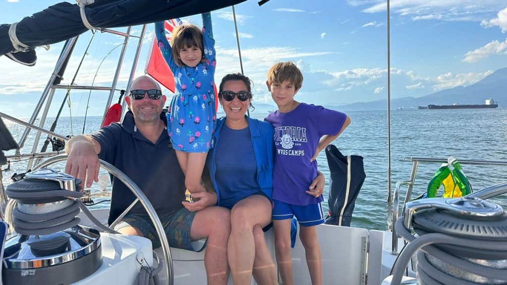 Larissa, Duncan, Skye and Eden hang out on their sailboat, Freeranger