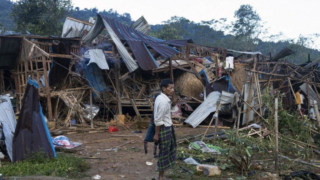 FILE - A man looks on at homes destroyed after air and artillery strikes in Mung Lai Hkyet displacement camp, in Laiza, Myanmar, Tuesday Oct. 10, 2023