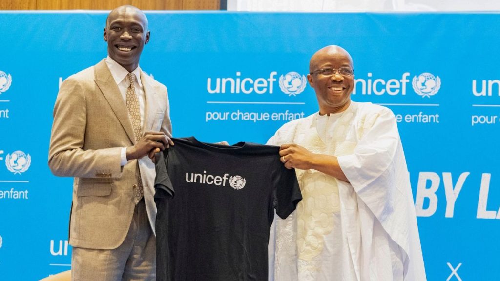 TikTok star Khaby Lame receives a T-shirt from UNICEF Regional Director for West and Central Africa Gilles Fagninou - Dakar, Senegal