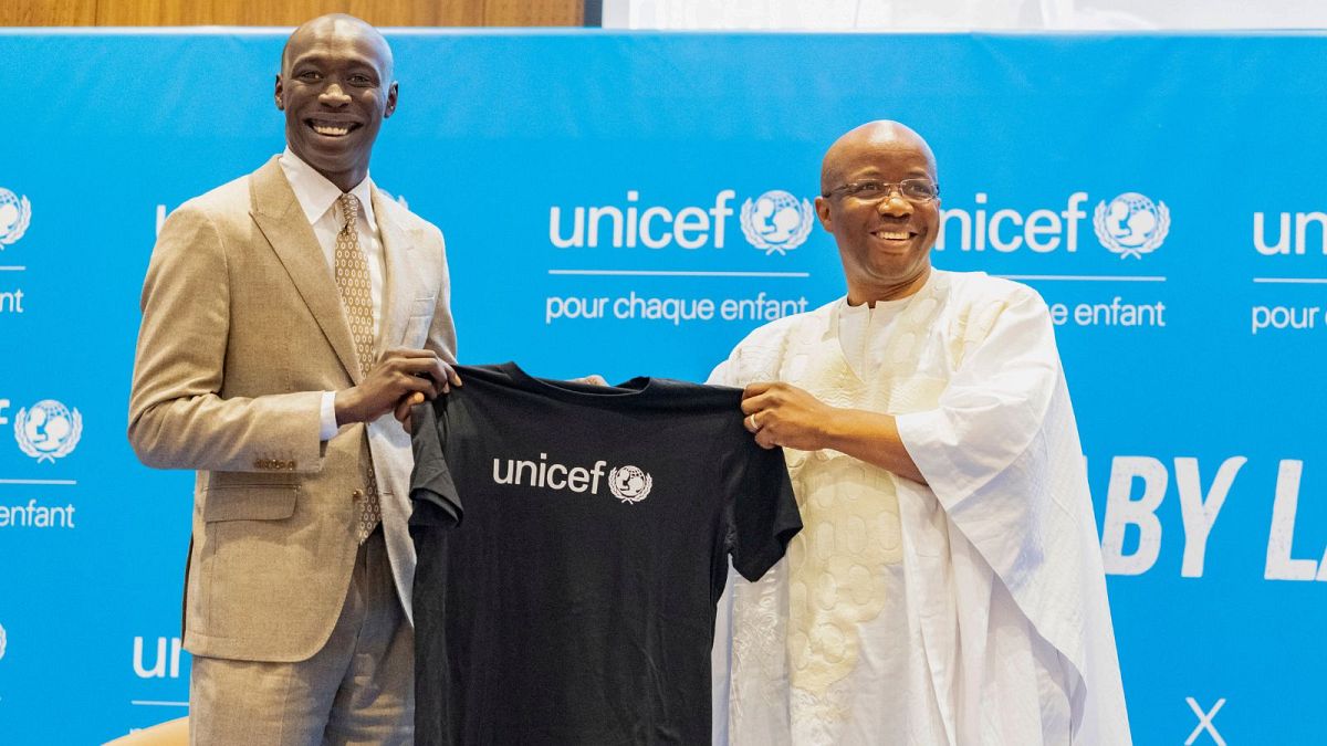 TikTok star Khaby Lame receives a T-shirt from UNICEF Regional Director for West and Central Africa Gilles Fagninou - Dakar, Senegal