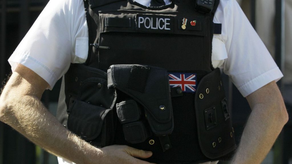 FILE - A police officer keeps watch in Westminster, in London, on March 28, 2012.