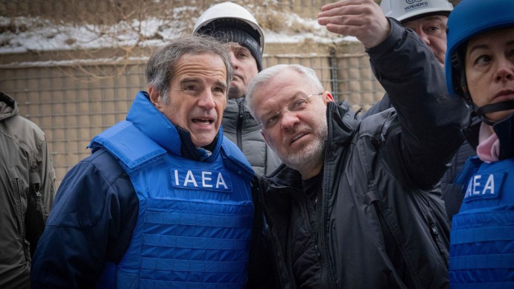 IAEA Director General Rafael Mariano Grossi and Minister of Energy of Ukraine Herman Galushchenko look at damaged transformers at a Kyiv substation.