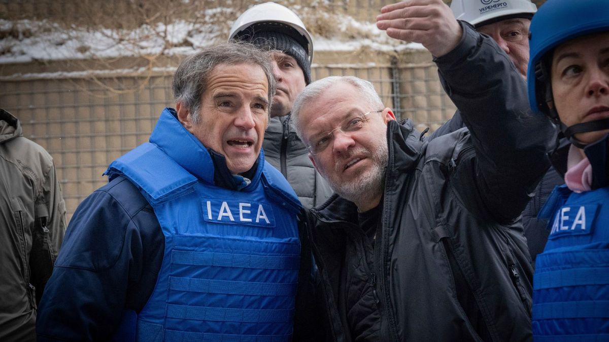 IAEA Director General Rafael Mariano Grossi and Minister of Energy of Ukraine Herman Galushchenko look at damaged transformers at a Kyiv substation.