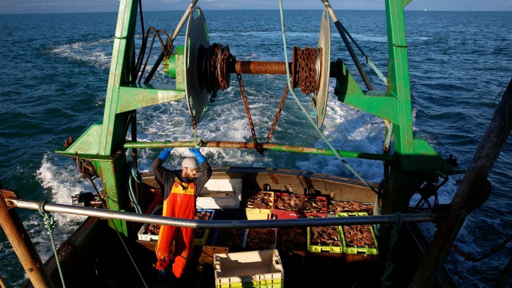 French fisherman tands aboard the trawler Le Chant des Sirenes at the limits of the French-UK waters, off Granville, Normandy.
