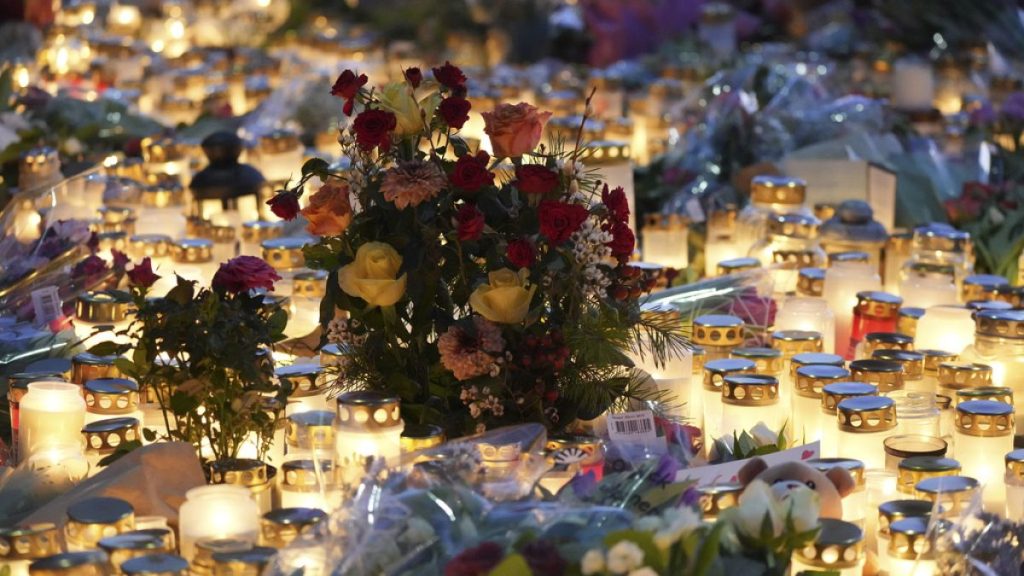 Flowers and candles near the scene of a shooting at an adult education center on the outskirts of Orebro, Sweden, Thursday, Feb. 6, 2025.