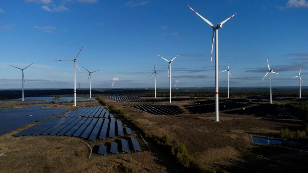 Wind turbines spin at the Klettwitz Nord solar energy park near Klettwitz, Germany.