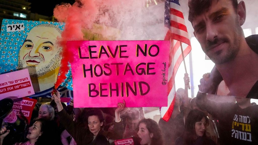 People attend a rally calling for the release of hostages held in the Gaza Strip in front of the US Embassy branch office in Tel Aviv, 4 February, 2025