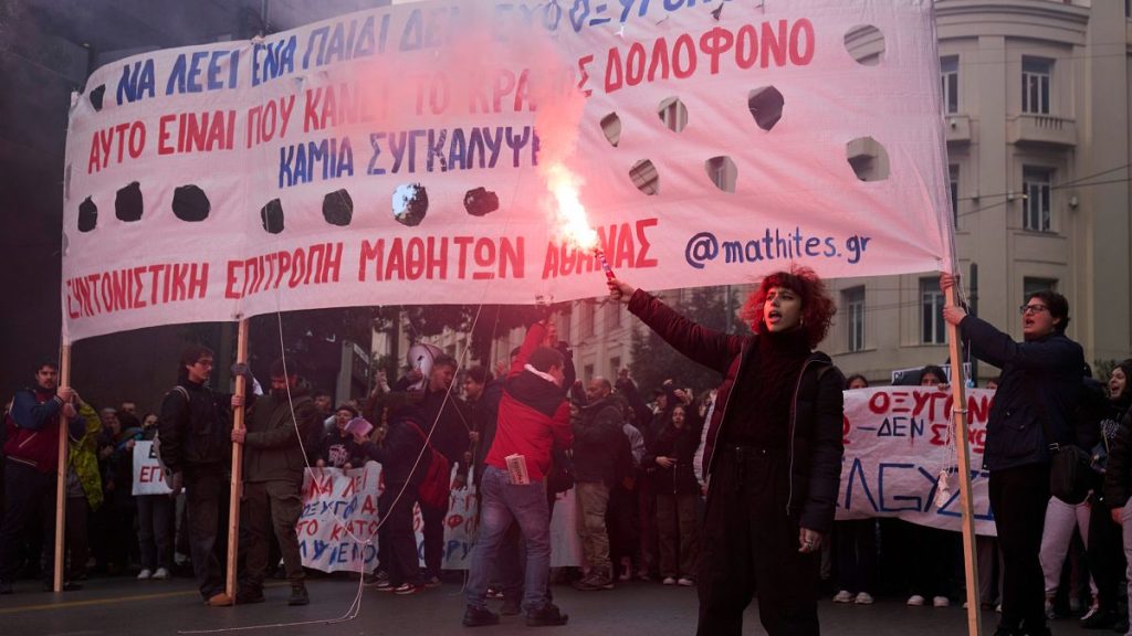 A student holds a flare as several thousand high school and university students take part in an anti-government protest in Athens, 7 February, 2025