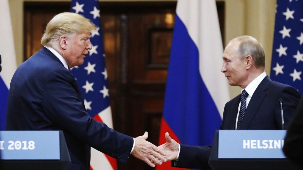 FILE - U.S. President Donald Trump shakes hands with Russian President Vladimir Putin at a news conference at the Presidential Palace in Helsinki, Finland, on July 16 2018