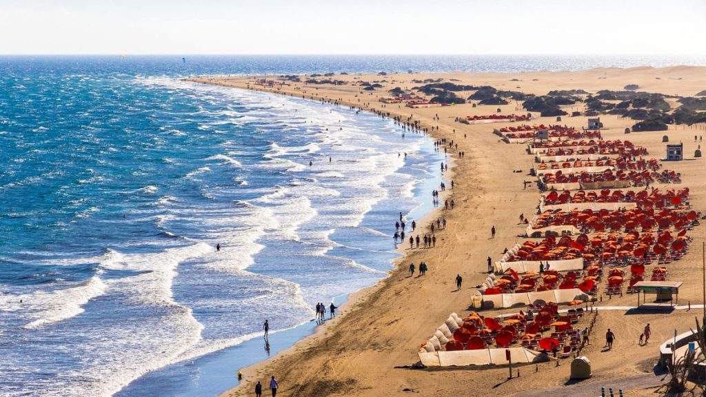 Tourists enjoying the sun on Maspalomas Beach in Gran Canaria