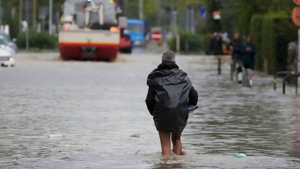 A man makes is way on a flooded street in Campi di Bisenzio, in the central Italian Tuscany region.