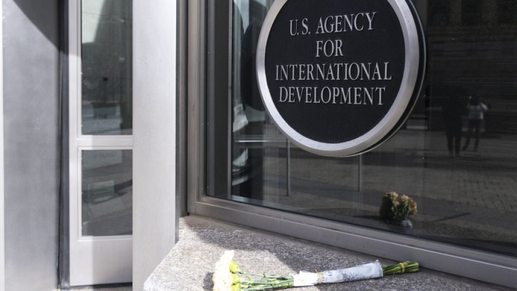 A bouquet of white flowers placed outside the headquarters of the United States Agency for International Development, or USAID, is pictured, Friday, Feb. 7, 2025