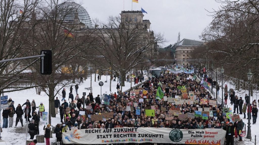 People demonstrate next to the Reichstag building to mark the nationwide climate strike by Fridays for Future, in Berlin, Friday Feb. 14, 2025