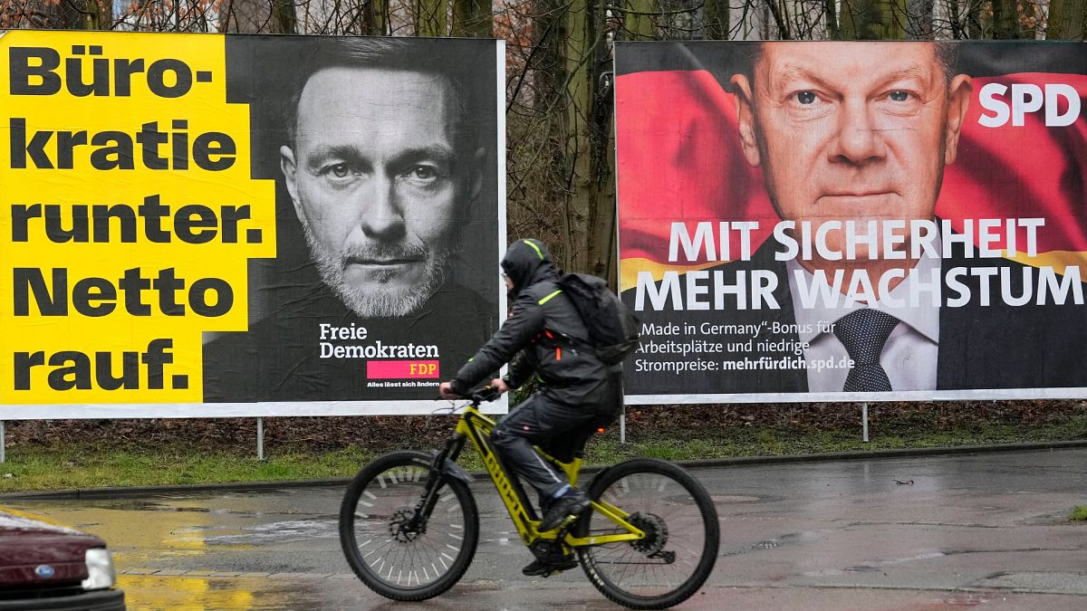 An election poster for the Liberal Democrats (FDP) with former finance minister Christian Lindner is seen beside a poster of the Social Democrats (SPD) with German chancellor.