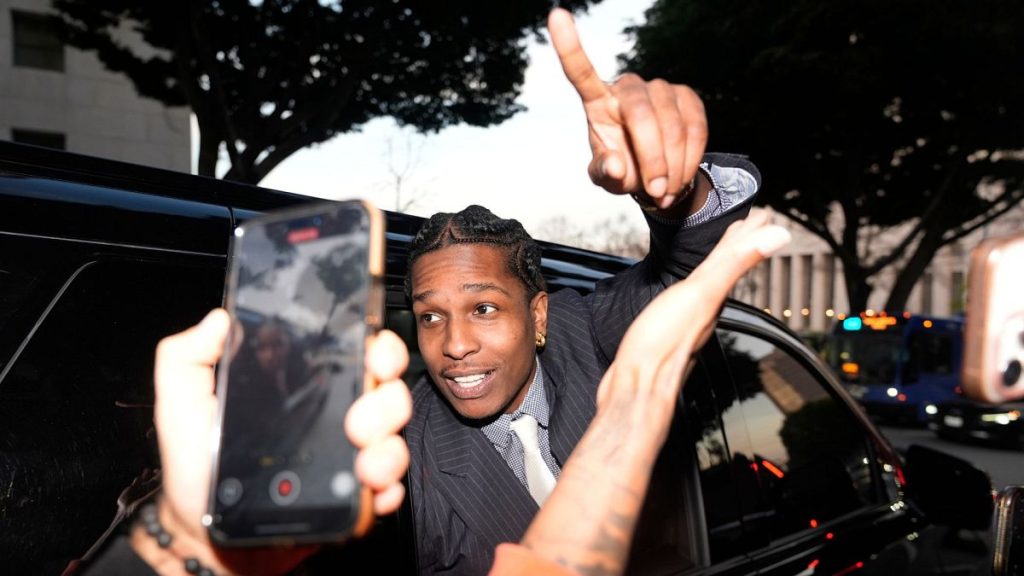 A$AP Rocky gestures out of the window of a vehicle while leaving court after he was found not guilty in his trial, 18 February 2025