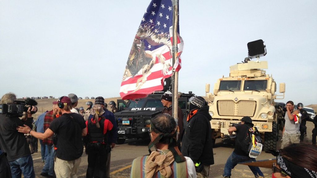 Dakota Access pipeline protesters defy law enforcement officers who are trying to force them from a camp on private land in the path of pipeline construction on 27 Oct 2016.