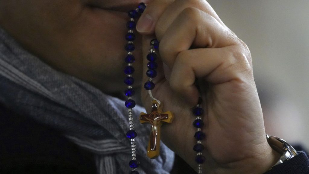 A man attends a rosary prayer service with Cardinal Luis Antonio Tagle held for the health of Pope Francis in St Peter