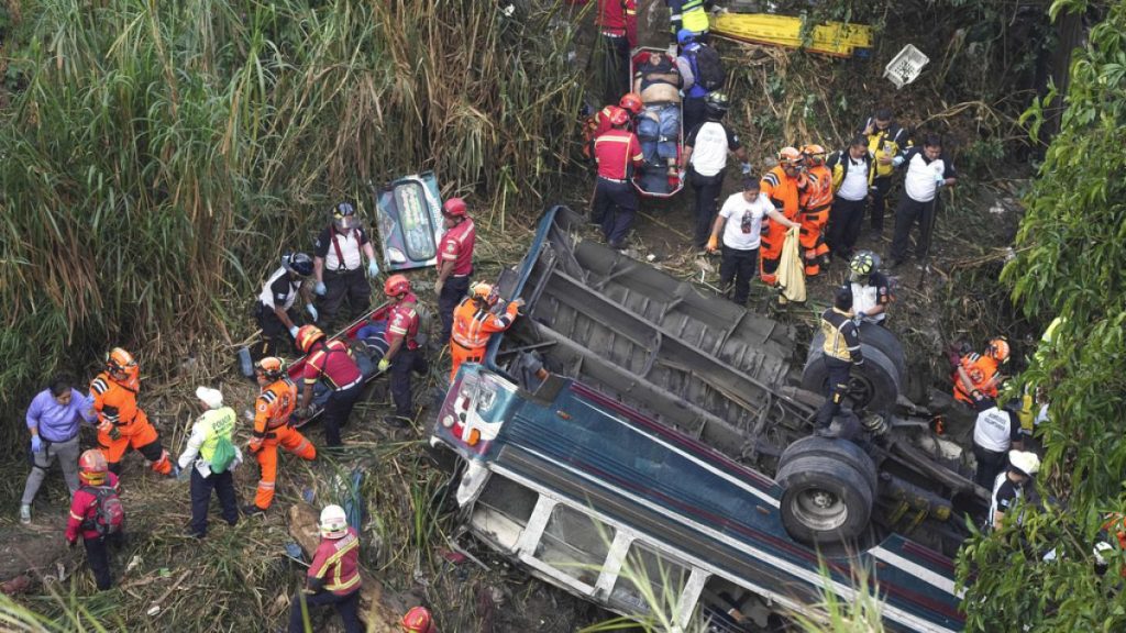 Firefighters work the scene of a fatal bus crash after it fell from a bridge on the outskirts of Guatemala City, Monday, Feb. 10, 2025