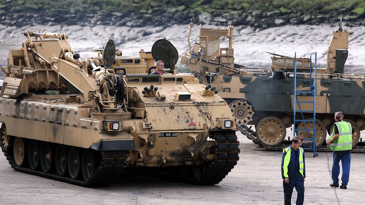 BAE employees move an armoured vehicle at the BAE Systems plant in Newcastle, England. 27 Sept. 2011.