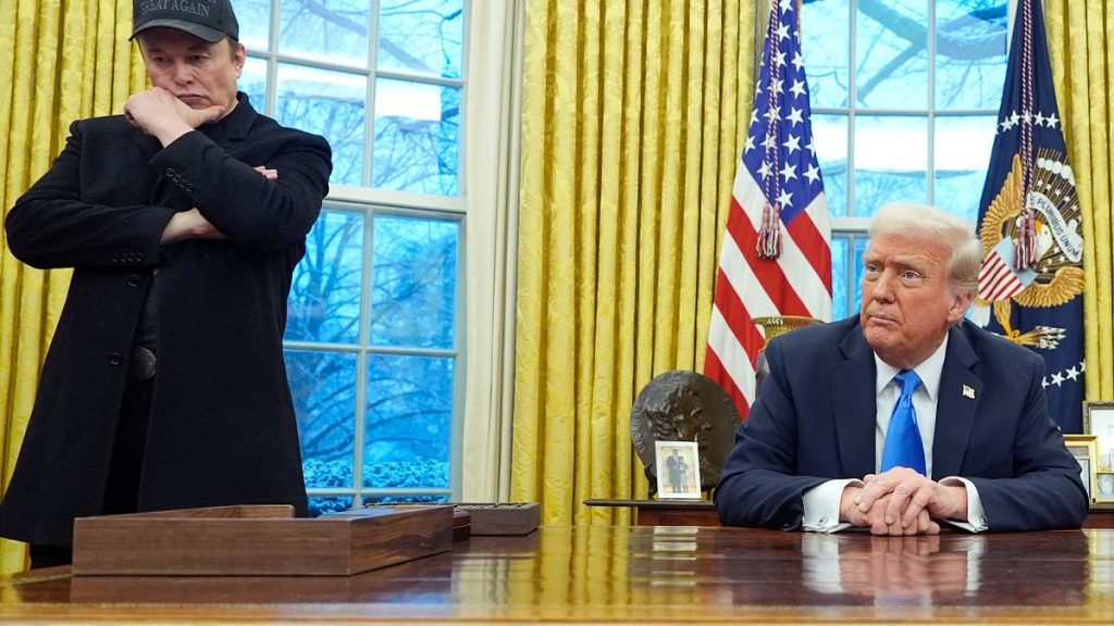 Elon Musk listens as President Donald Trump speaks with reporters in the Oval Office at the White House, 11 February 2025, Washington.