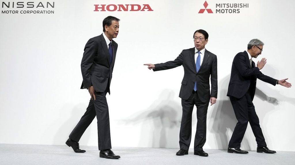 Nissan Chief Executive Makoto Uchida, left, Takao Kato, CEO of Mitsubishi Motors, centre, and Honda Chief Executive Toshihiro Mibe, right, at a news conference last year