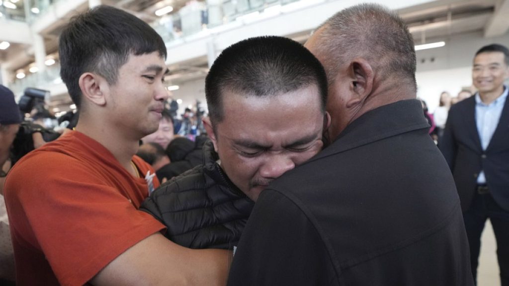Pongsak Thaenna, center, a Thai hostage who was freed from Hamas, hugs a relative at the airport, in Samut Prakarn Province, Thailand, Sunday, Feb. 9, 2025