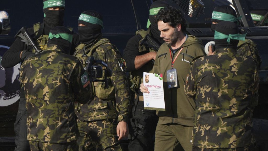 Israeli Ofer Kalderon who has been held hostage by Hamas in Gaza since October 7, 2023, walks next to Hamas fighters before being handed over to the Red Cross