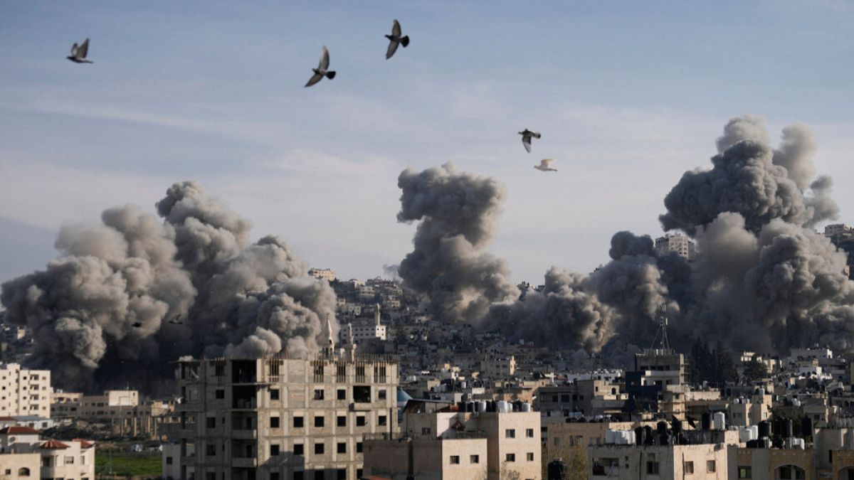 Smoke rises following an explosion detonated by the Israeli army, which said it was destroying buildings used by Palestinian militants in the West Bank Jenin refugee camp.