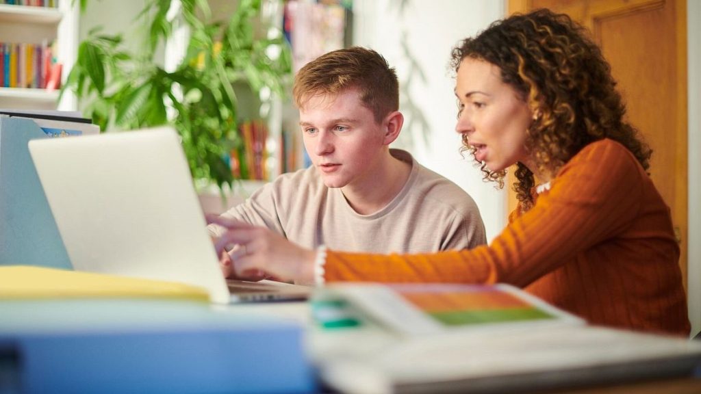 Students look at a computer screen.