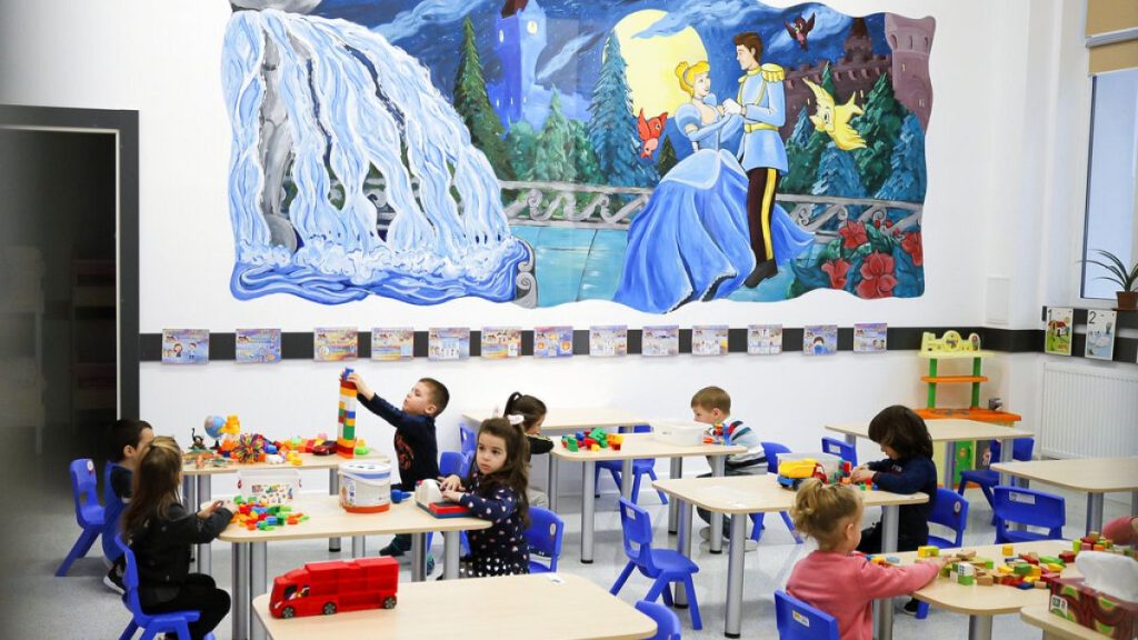 Kindergarten children play a classroom during a visit by local administration officials, on the opening day of schools and kindergartens in Bucharest, Romania, Monday, Feb. 8,