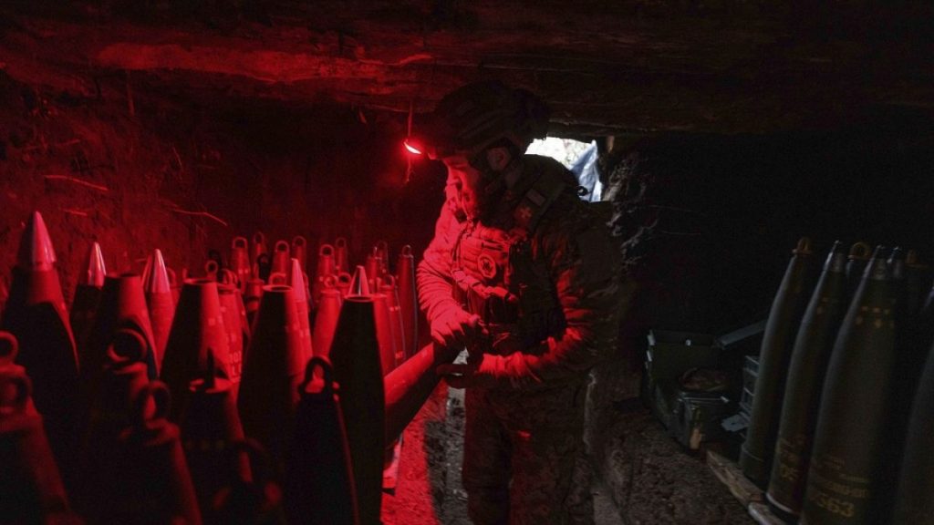 A Ukrainian serviceman of the 148th artillery brigade prepares 155mm artillery shells for a M777 howitzer before firing towards Russian positions at the frontline.